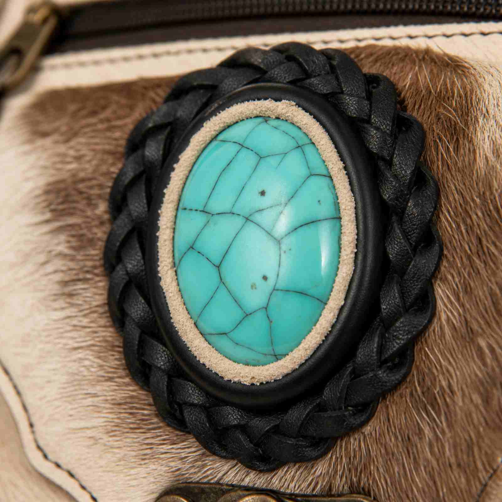 Detail van turquoise steen op boho heuptasje leer