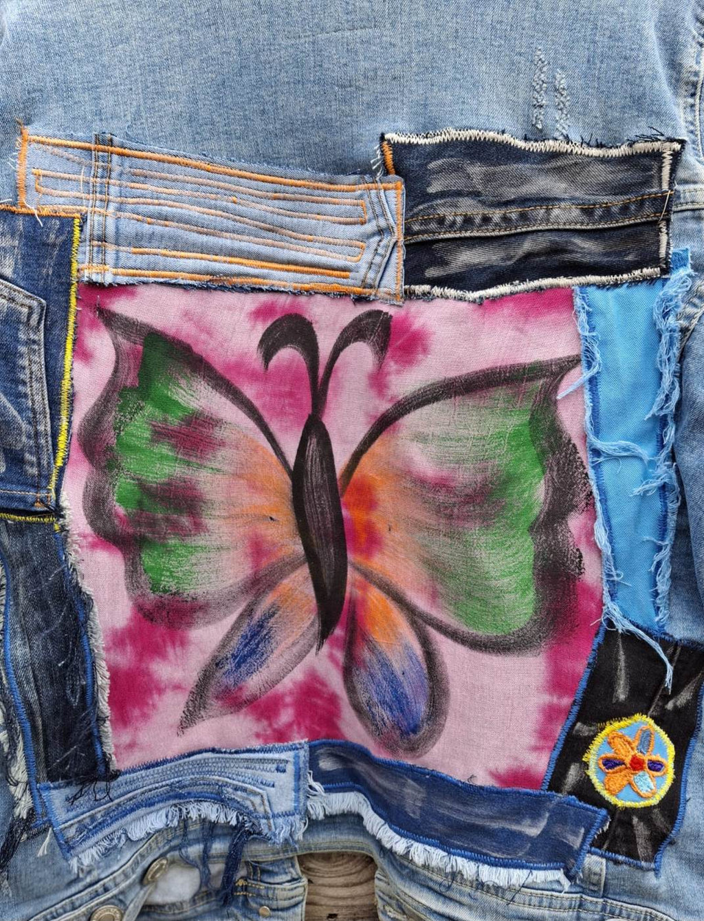 Butterfly artwork op upcycled denim jacket