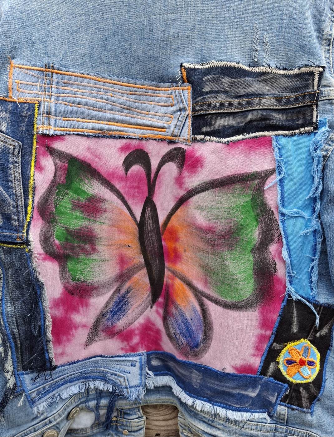 Butterfly artwork op upcycled denim jacket