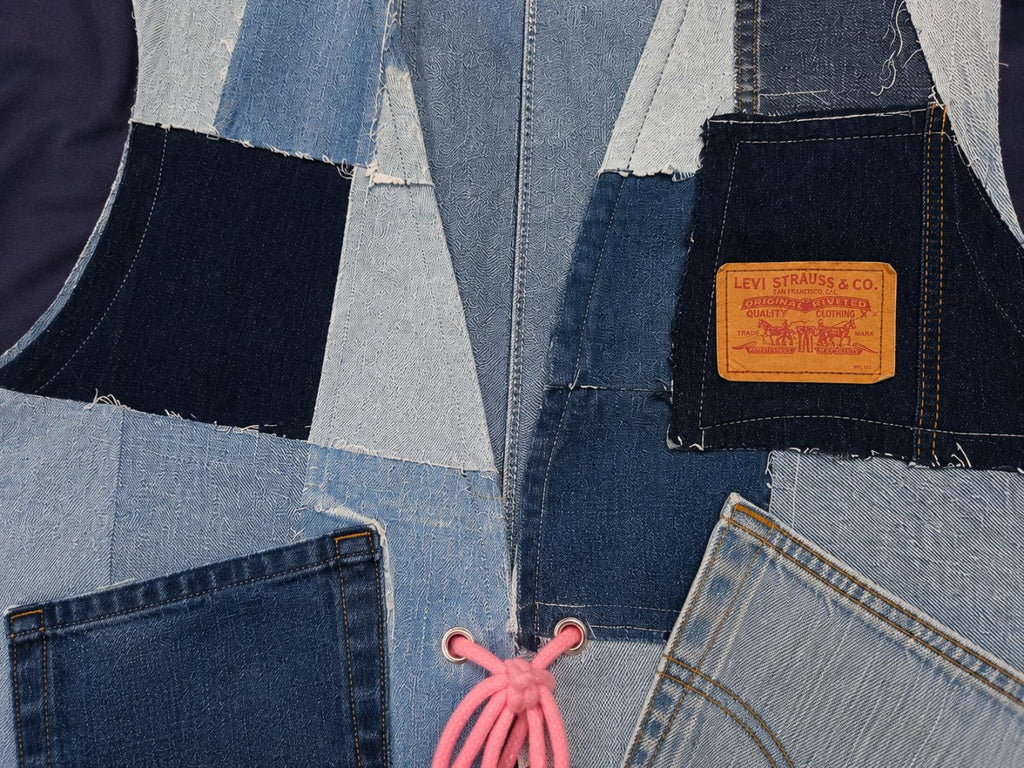 Close-up van het handgemaakte denim patchwork op de voorzijde van Blue Nomad L/XL.