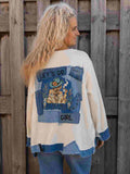 Handgemaakte Let's Go Girl top van Old New Atelier met denim applicaties en illustratie op de rug, gedragen door model.
