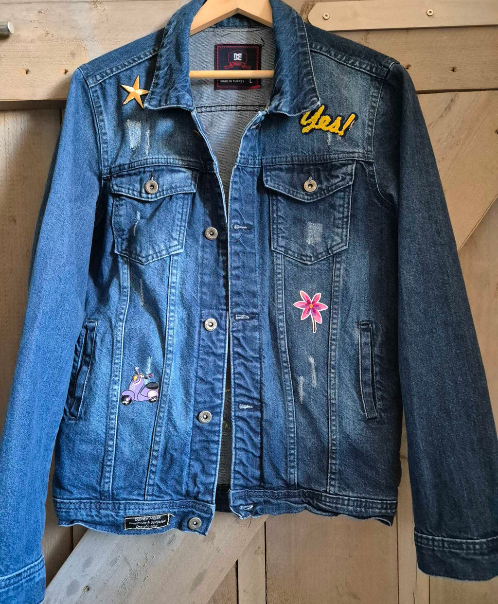 Front of upcycled denim jacket with patches and bohemian style details