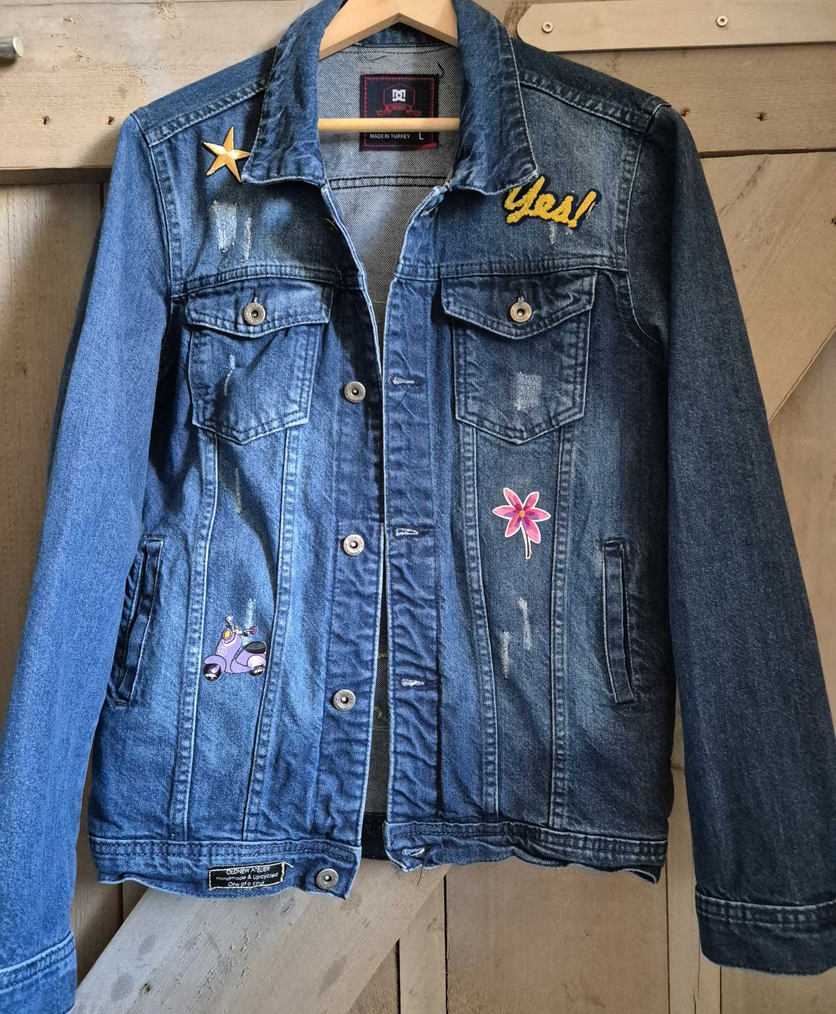 Front of upcycled denim jacket with patches and bohemian style details